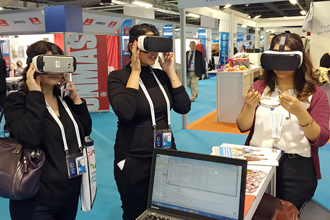 Visitors to UN Women’s booth view UN Women’s Virtual Reality Film  Photo: UN Women/Sharon Grobeisen