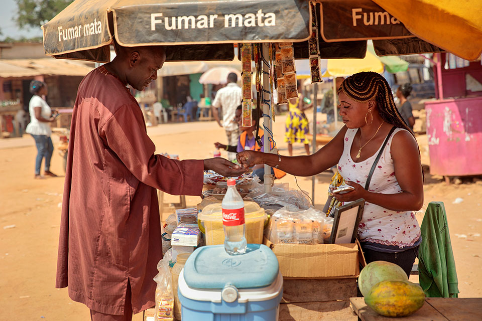 Dorothee Mbogo operates a “call box” roadside retail stand in Bachenga. Photo: UN Women/Ryan Brown