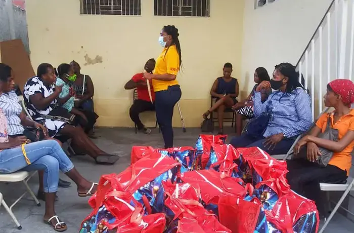 IDEH workers provide hygiene kits to women with disabilities during a COVID-19 information session.