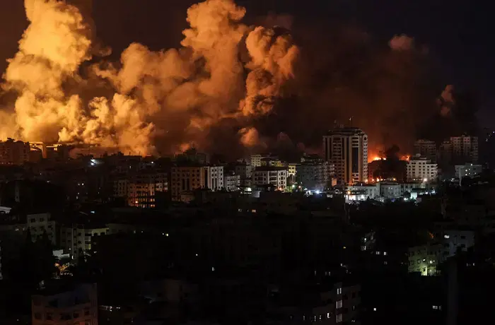 Flames and smoke billow during Israeli strikes in Gaza on 9 October 2023. 