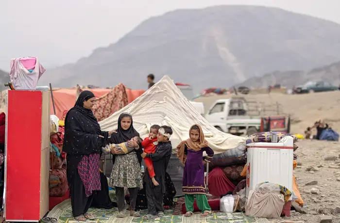 A woman and children are seen at the Torkham crossing point in Nangarhar, eastern Afghanistan, in November 2023 after they had been forced to return from Pakistan.