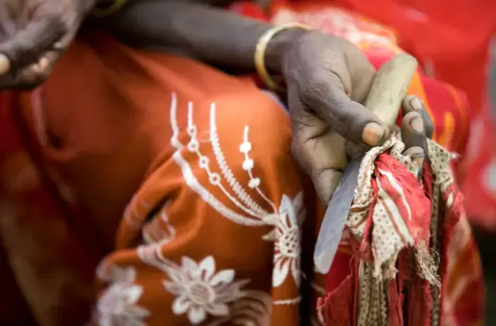 Boko Mohammed, a former excisor (a practitioner who performs female genital mutilation), holds the tool she used to perform the procedure at a community meeting in Kabele Village, inAmibara District, Afar Region.