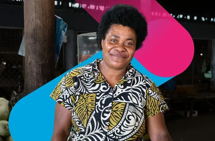 A portrait of a woman fruit vendor at a market in Fiji