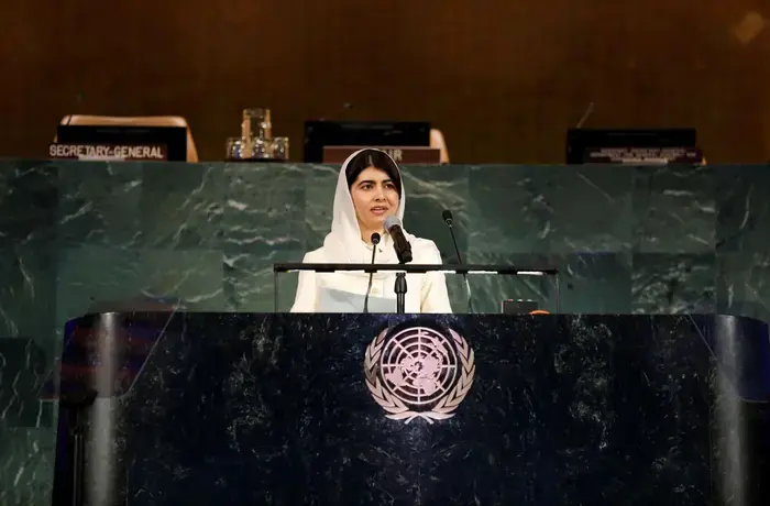 Malala Yousafzai speaks from a podium