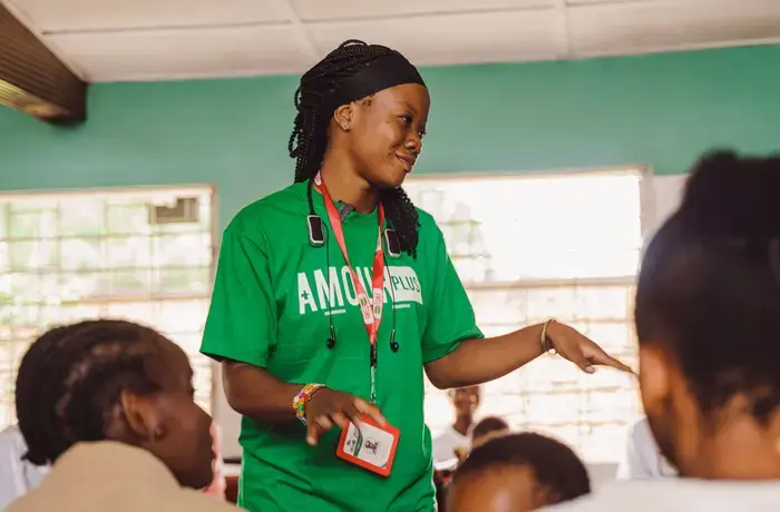 A woman stands to address a group of people