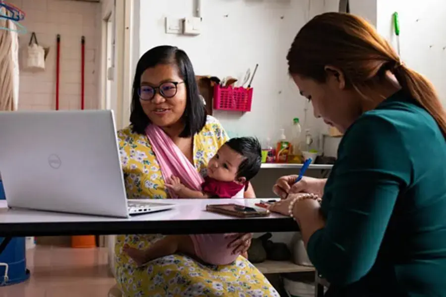 Deborah and Kip, from the Myanmar Ethnic Women Refugee Organization, conducting a virtual support group session with other refugee women.  © UNHCR/Patricia Krivanek