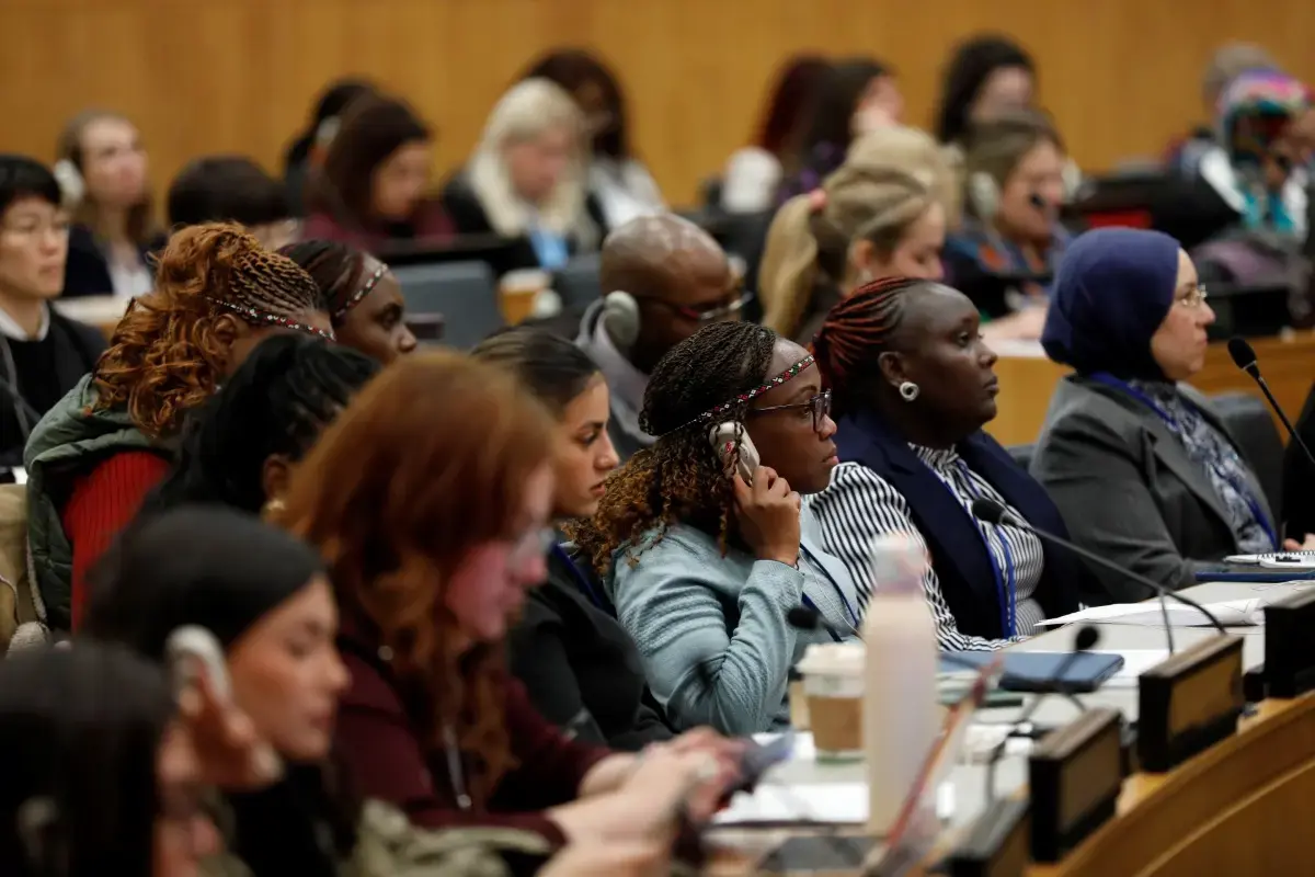 Members of the audience listen to translations using headsets