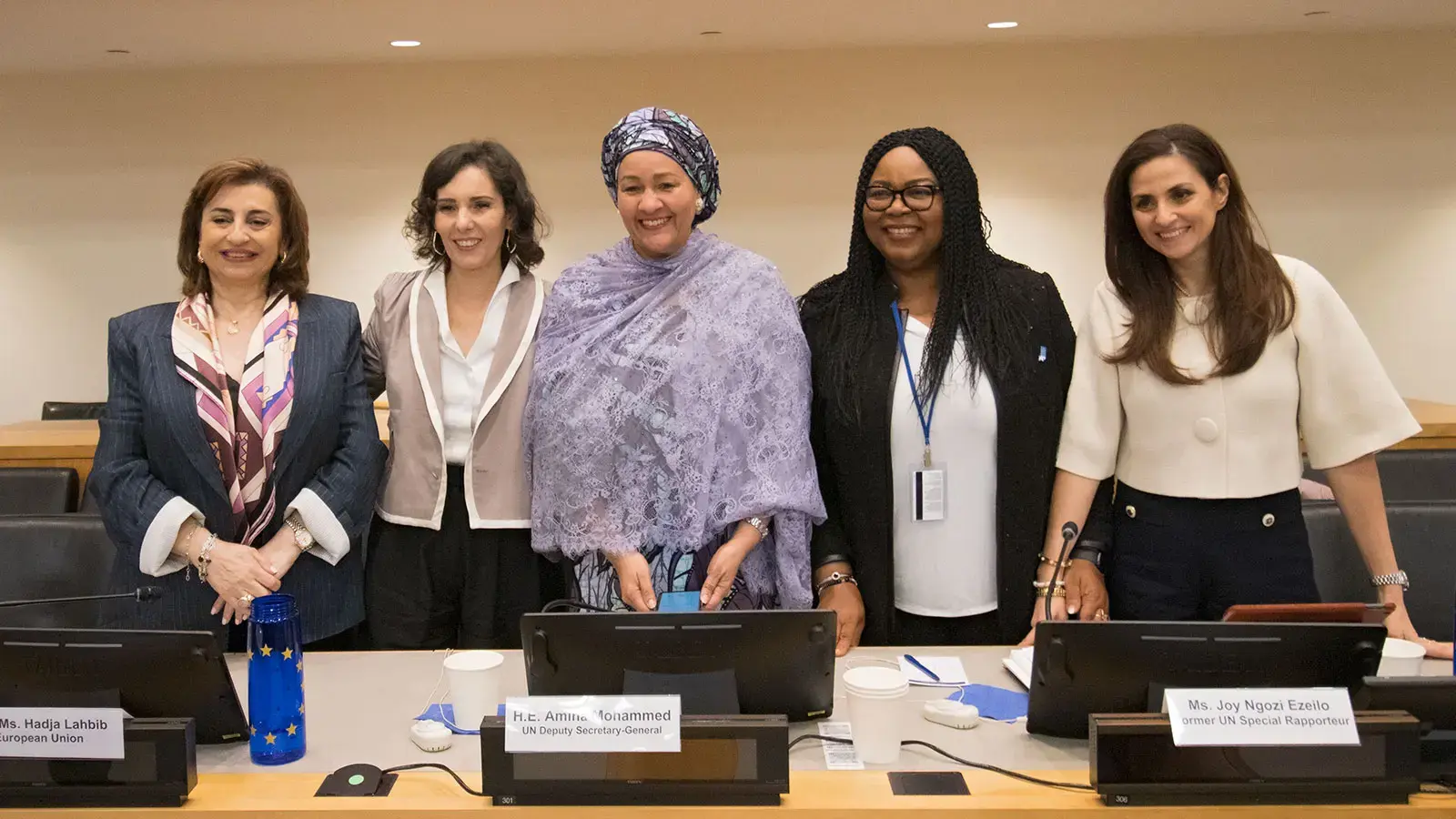 5 panelists stand together for a group photo