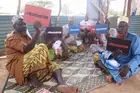 Men hold anti FGM signs at awareness training sessions