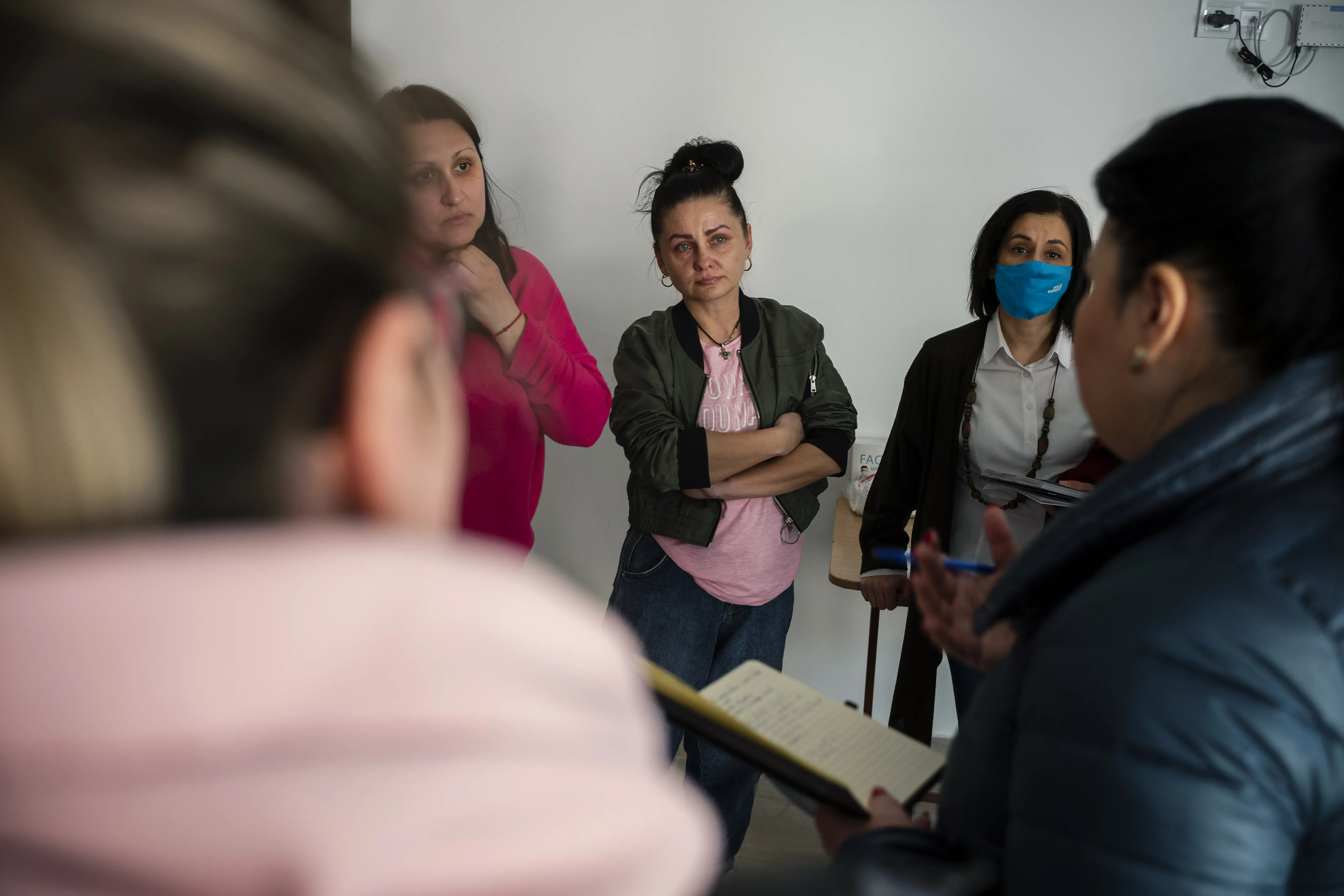 Snejana, 41, from Odessa, discussing with UN Women team at a temporary placement center in Scoreni, Straseni district, Moldova. 
