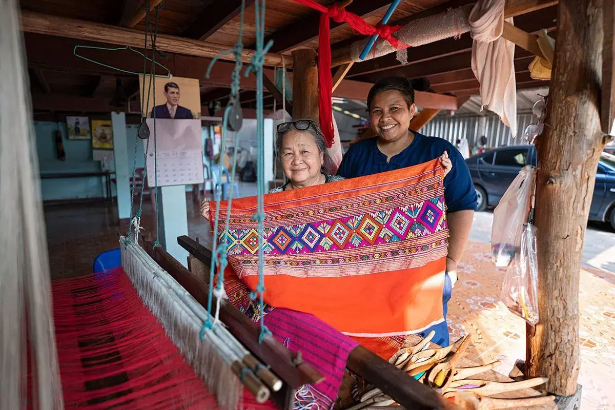 With intricate weaving patterns in hand, Chananya reassures the community that traditional silk robes can gain value through creativity and craftmanship