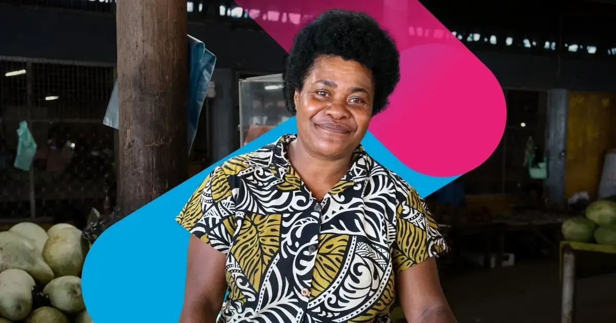 A portrait of a woman fruit vendor at a market in Fiji