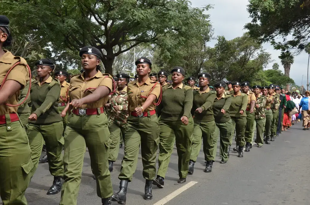 Women police march down a street